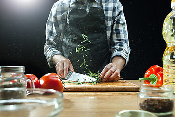 Image showing Preparing salad. Female chef cutting fresh vegetables. Cooking process. Selective focus