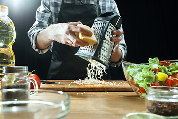 Image showing Preparing salad. Female chef cutting fresh vegetables. Cooking process. Selective focus