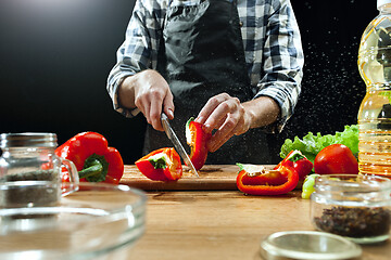 Image showing Preparing salad. Female chef cutting fresh vegetables. Cooking process. Selective focus