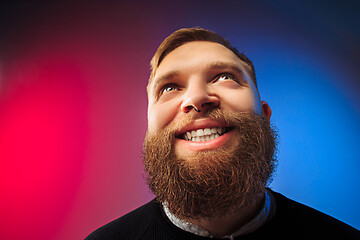 Image showing The happy man standing and smiling against pink background.