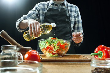 Image showing Preparing salad. Female chef cutting fresh vegetables. Cooking process. Selective focus