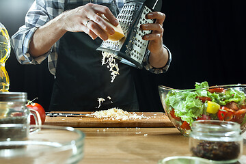 Image showing Preparing salad. Female chef cutting fresh vegetables. Cooking process. Selective focus