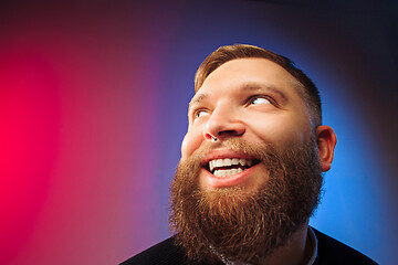 Image showing The happy man standing and smiling against pink background.