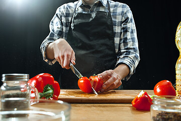 Image showing Preparing salad. Female chef cutting fresh vegetables. Cooking process. Selective focus