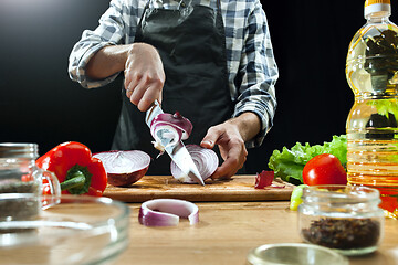 Image showing Preparing salad. Female chef cutting fresh vegetables. Cooking process. Selective focus