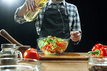 Image showing Preparing salad. Female chef cutting fresh vegetables. Cooking process. Selective focus