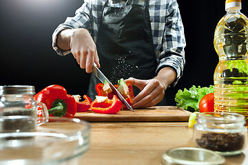 Image showing Preparing salad. Female chef cutting fresh vegetables. Cooking process. Selective focus