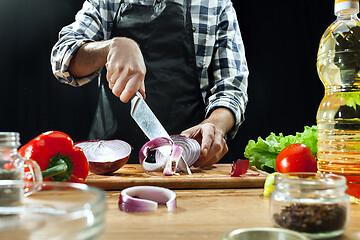 Image showing Preparing salad. Female chef cutting fresh vegetables. Cooking process. Selective focus