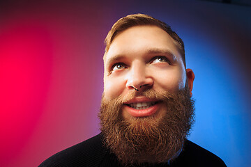 Image showing The happy man standing and smiling against pink background.