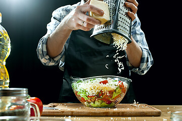 Image showing Preparing salad. Female chef cutting fresh vegetables. Cooking process. Selective focus