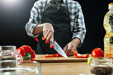 Image showing Preparing salad. Female chef cutting fresh vegetables. Cooking process. Selective focus