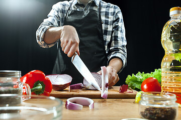 Image showing Preparing salad. Female chef cutting fresh vegetables. Cooking process. Selective focus