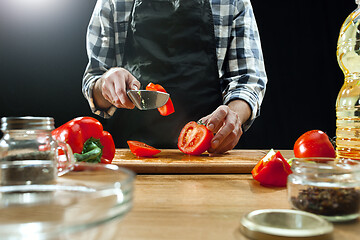 Image showing Preparing salad. Female chef cutting fresh vegetables. Cooking process. Selective focus