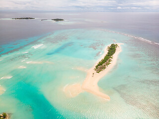 Image showing Picture perfect beach and turquoise lagoon on small tropical island on Maldives