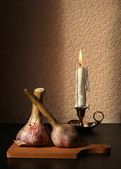 Image showing Two garlic bulbs and candle