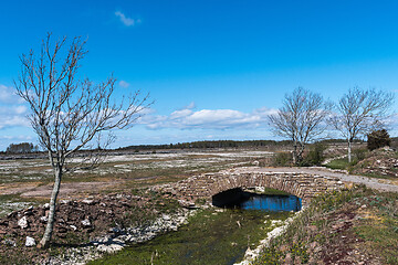 Image showing Old limestone stonebridge in a plain landscape