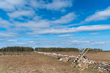 Image showing Old wooden stile by a boundry