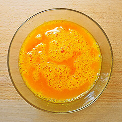 Image showing Blending mix of hen eggs in transparent bowl on the kitchen tabl