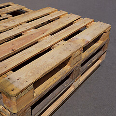 Image showing Used wooden pallets lying on the asphalt pavement