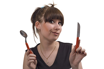 Image showing The mad housewife with knife and spoon. funny picture