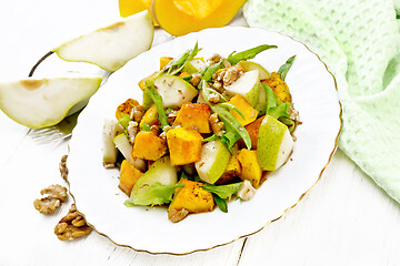 Image showing Salad of pumpkin and pear in plate on light board