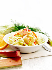 Image showing Salad of cabbage and rhubarb in plate on wooden board
