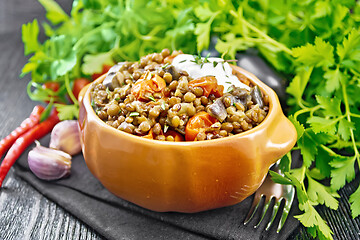 Image showing Lentils with eggplant and tomatoes in bowl on board