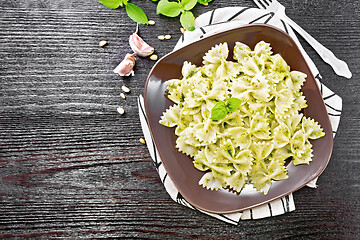 Image showing Farfalle with pesto in plate on board top