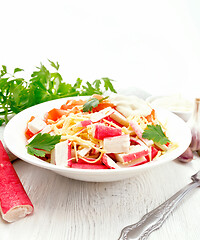 Image showing Salad of surimi and tomatoes on light table