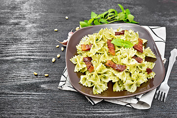 Image showing Farfalle with pesto and bacon on board