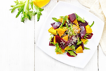 Image showing Salad of pumpkin and beetroot in plate on board top