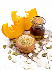 Image showing Flour pumpkin in bowl on wooden board