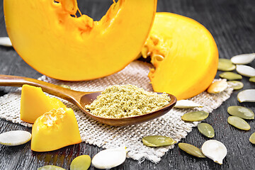 Image showing Flour pumpkin in spoon on dark board