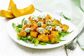 Image showing Salad of pumpkin and cheese in plate on board