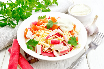 Image showing Salad of surimi and tomatoes on table