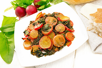 Image showing Radish with spinach and spices in plate on wooden board