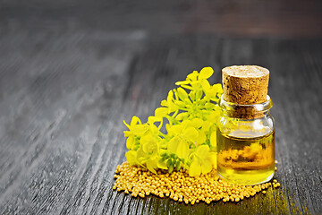 Image showing Oil mustard in bottle the dark board