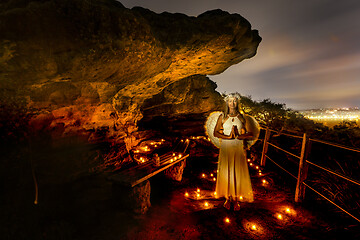 Image showing Praying angle surrounded by tea light candles