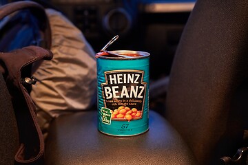 Image showing Can of beans open on the back seat of a car