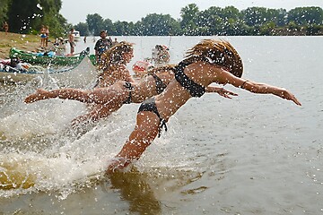Image showing Girls jumping in the river