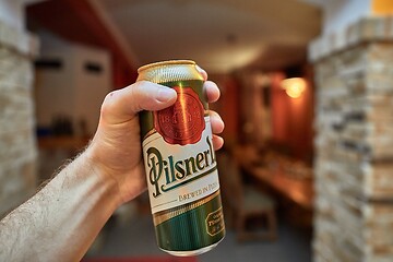 Image showing Holding beer in a house