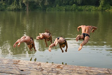 Image showing People jumping in the river from a pier