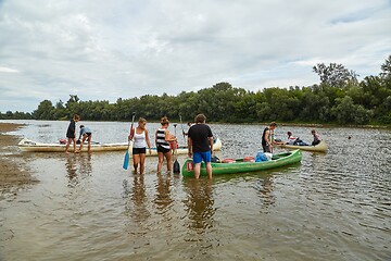 Image showing Canoes on the Riverside, People preparing for a trip