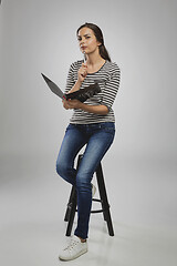 Image showing Woman sitting on a bench while think