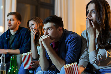 Image showing friends with beer and popcorn watching tv at home