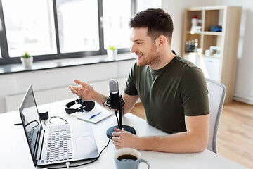 Image showing blogger with laptop and microphone audio blogging