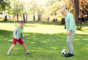 Image showing old man and boy playing football at summer park