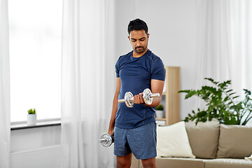 Image showing indian man exercising with dumbbells at home