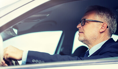 Image showing happy senior businessman driving car