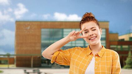 Image showing red haired teenage girl showing peace over school